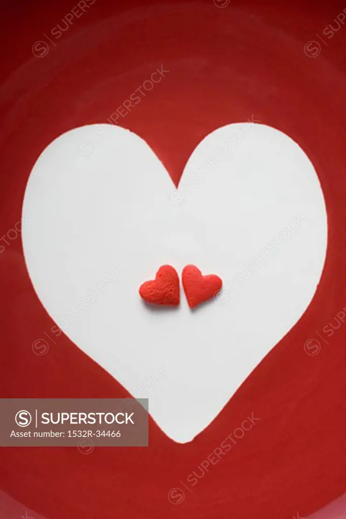Two red sugar hearts in a white heart