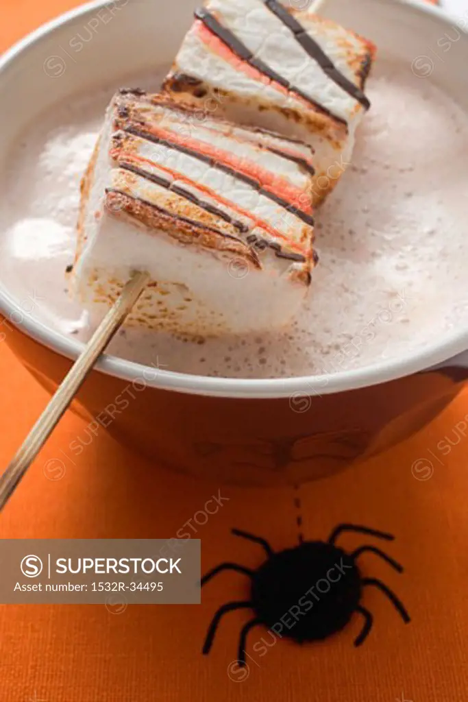 Cocoa with marshmallows on stick for Halloween