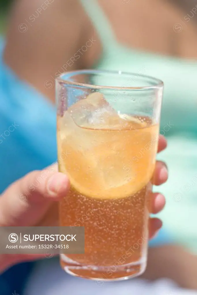 Woman holding a glass of iced tea