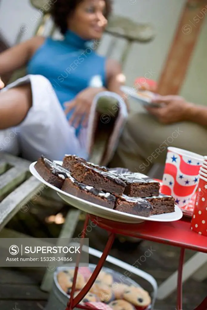 Brownies at a garden party for 4th of July, woman in background