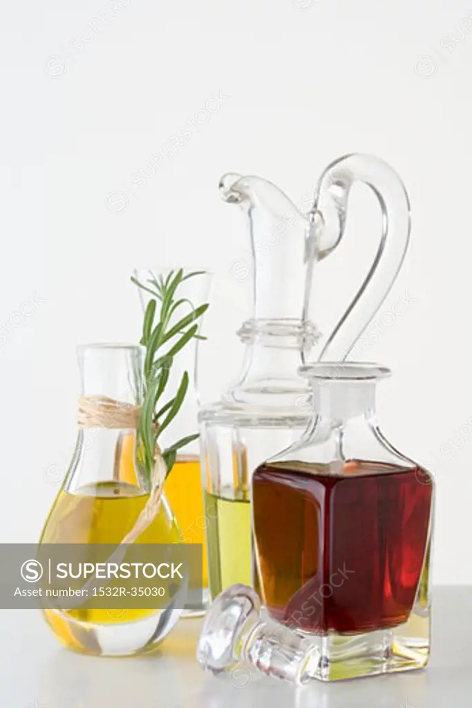 Various types of oil in carafes & bottle of balsamic vinegar