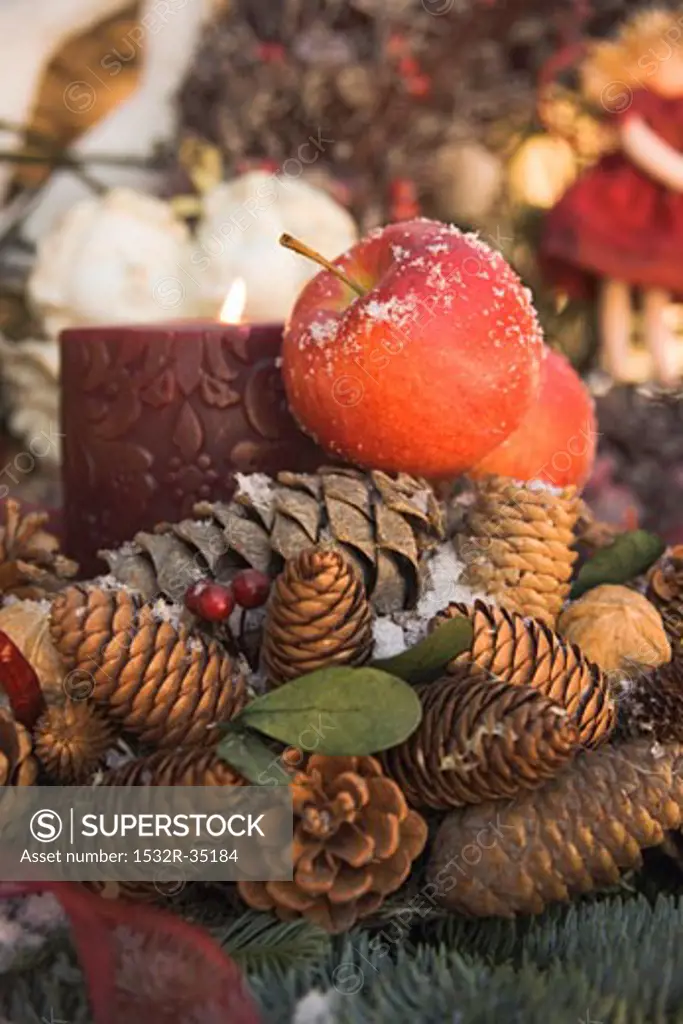 Christmas decorations: cones, red apples and candle