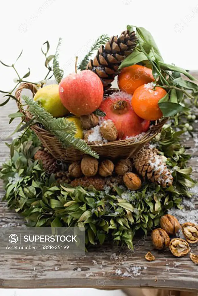 Christmas decoration: fruit, nuts, cones and box wreath
