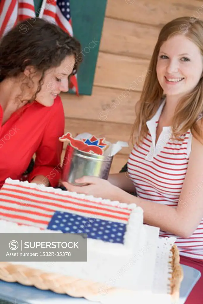 Two women with cookies and cake on the 4th of July (USA)