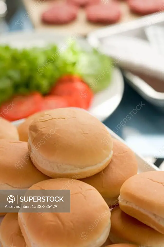 Hamburger buns, salad and burgers