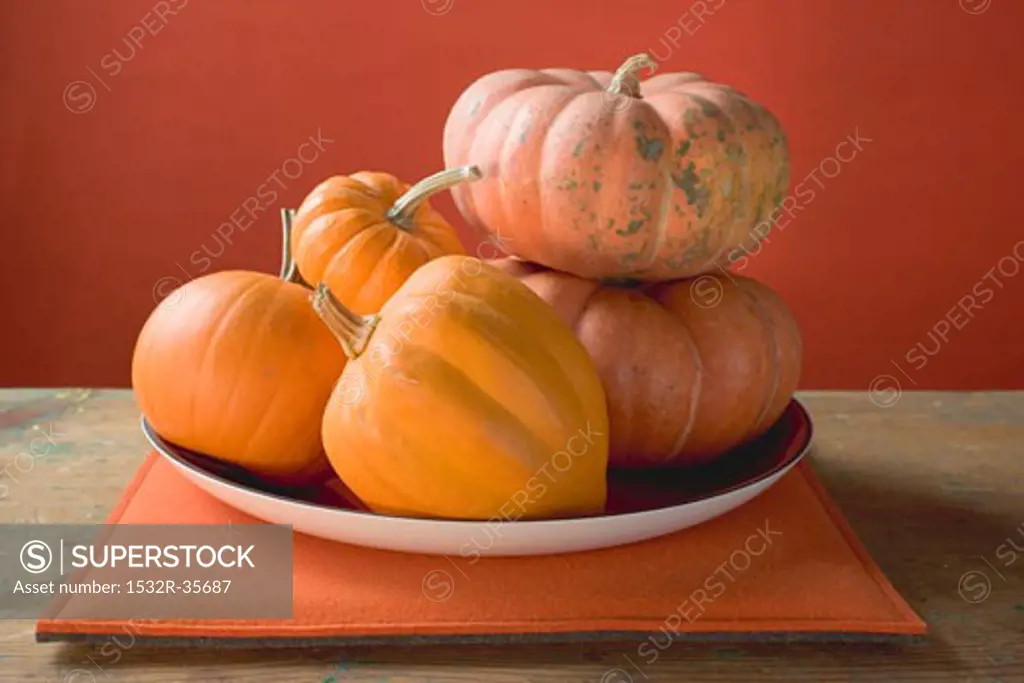 Orange pumpkins on plate