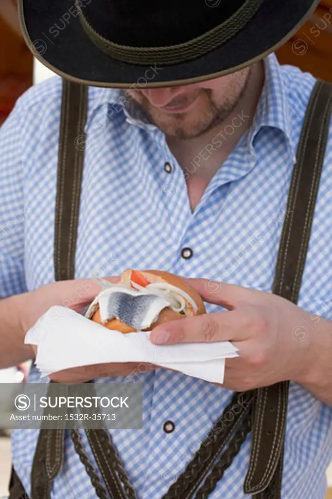 Man eating herring roll at Oktoberfest