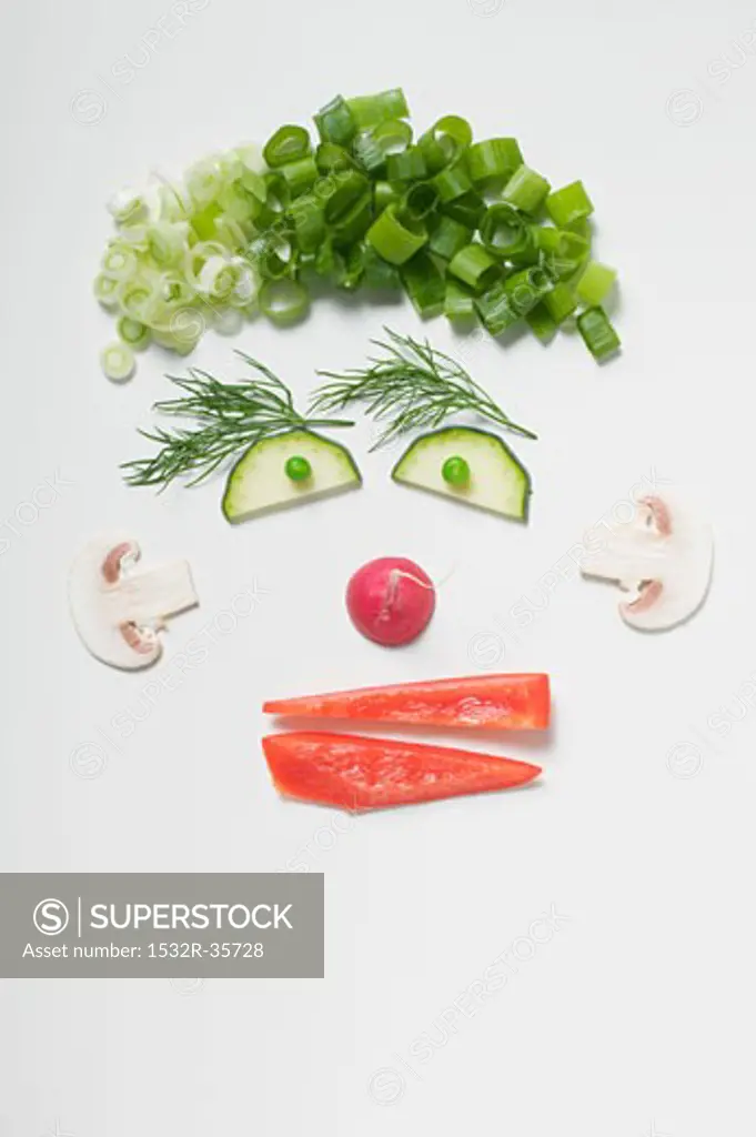 Amusing face made from vegetables, dill and mushrooms