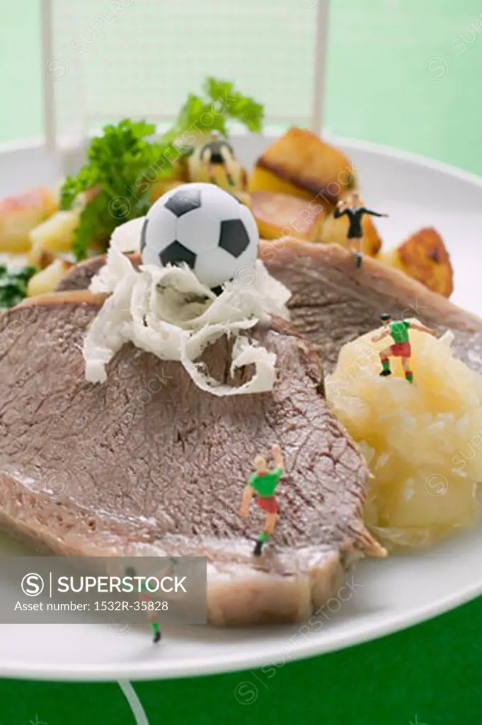 Boiled beef with accompaniments and football figures