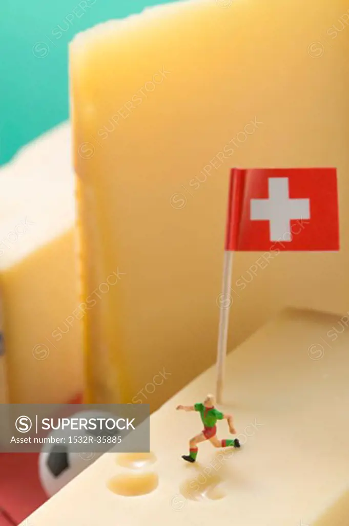 Swiss cheese with football figure, football and flag