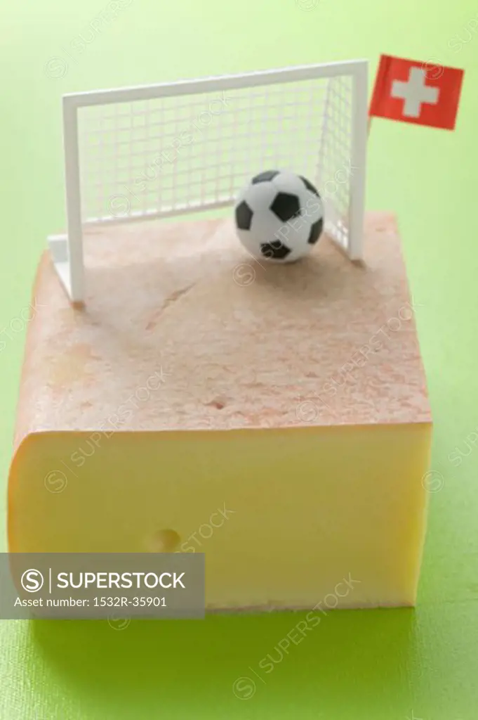 Swiss raclette cheese with football decoration and flag