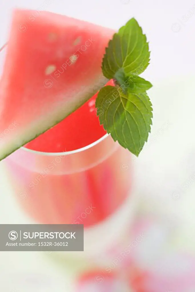 Watermelon drink with wedge of watermelon and mint leaves