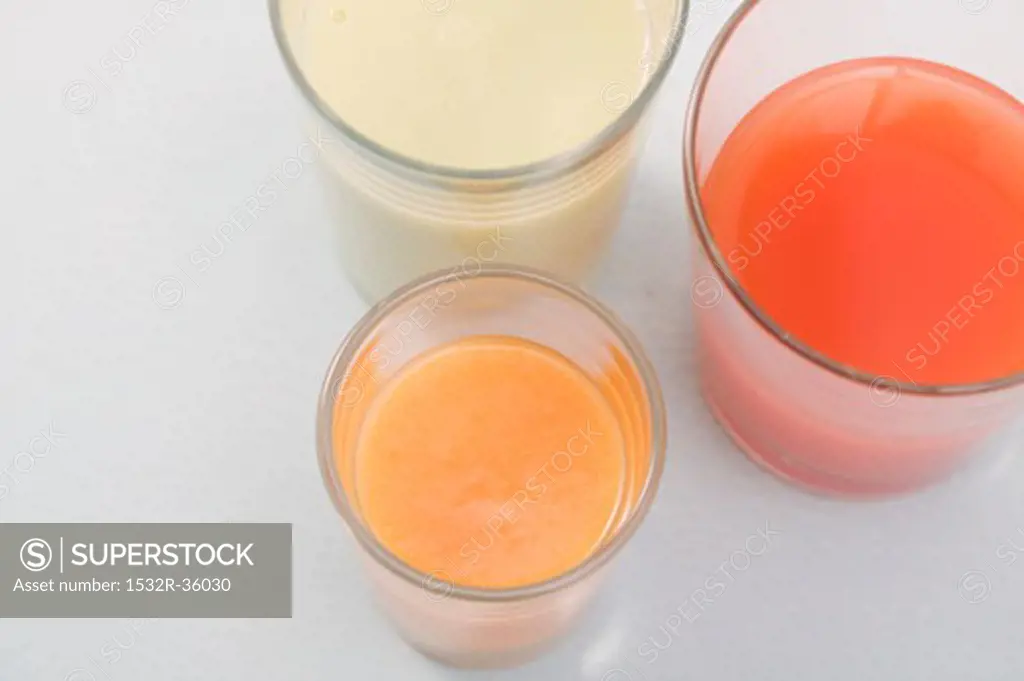 Three different juices in glasses (overhead view)