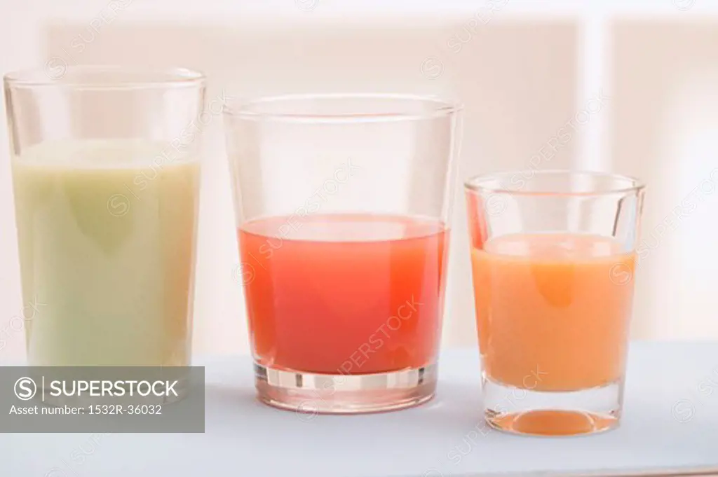 Three different juices in glasses, side by side