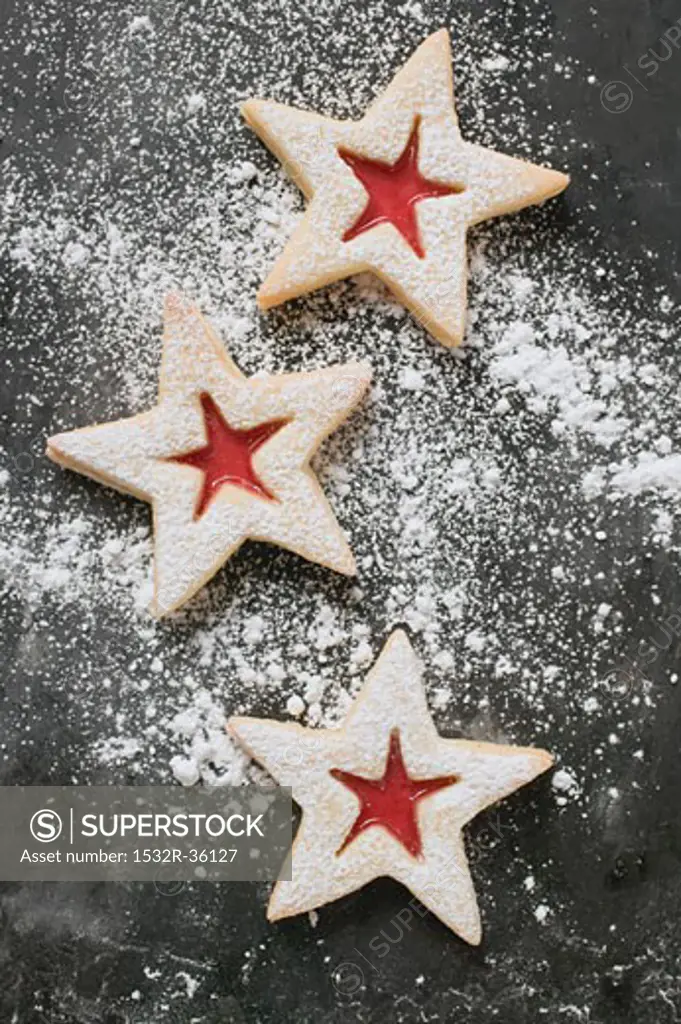 Three jam biscuits with icing sugar