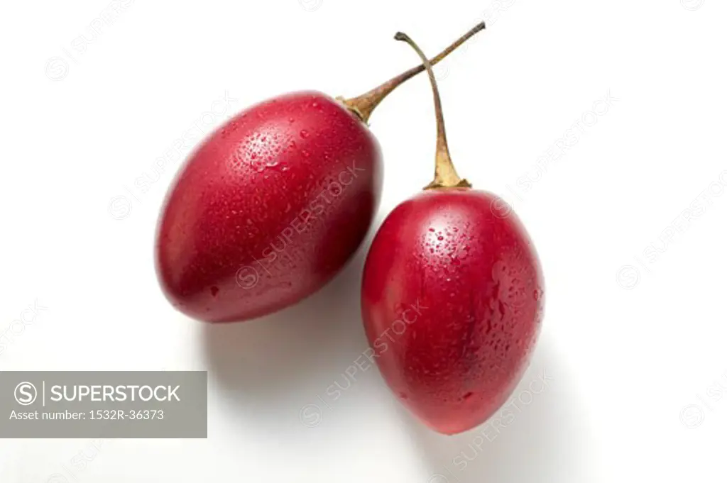 Two tamarillos with drops of water