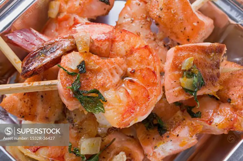 Salmon and prawn skewers with mint in aluminium dish