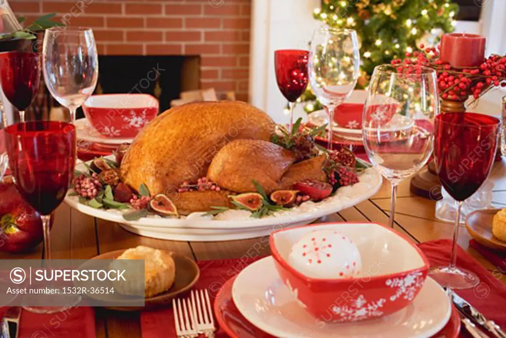 Roast turkey on Christmas table in front of fireplace