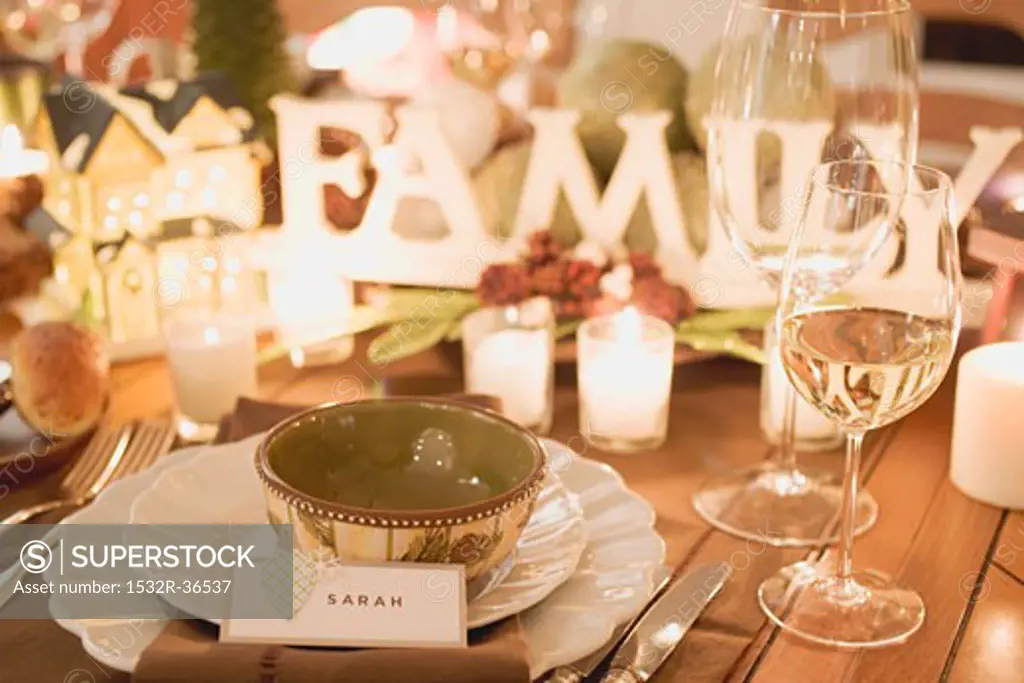 Christmas place-setting with place card, wine glasses