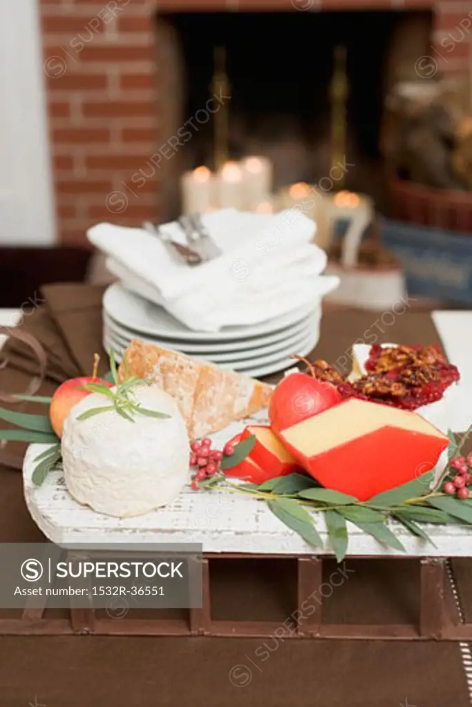 Cheese and apples on small sleigh for Christmas