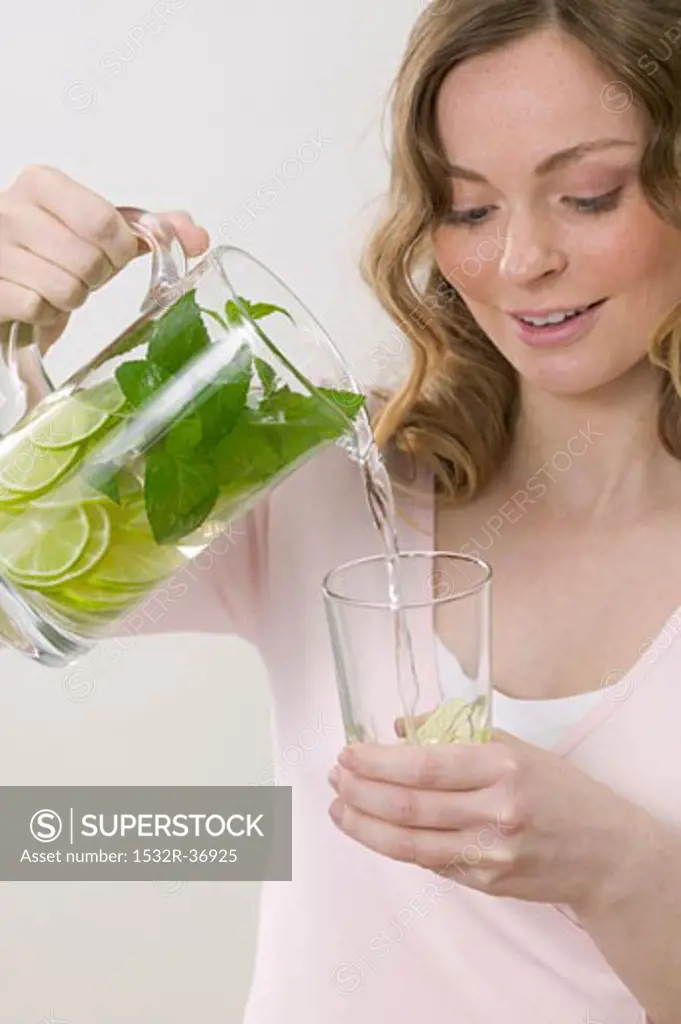 Woman pouring lemonade into glass
