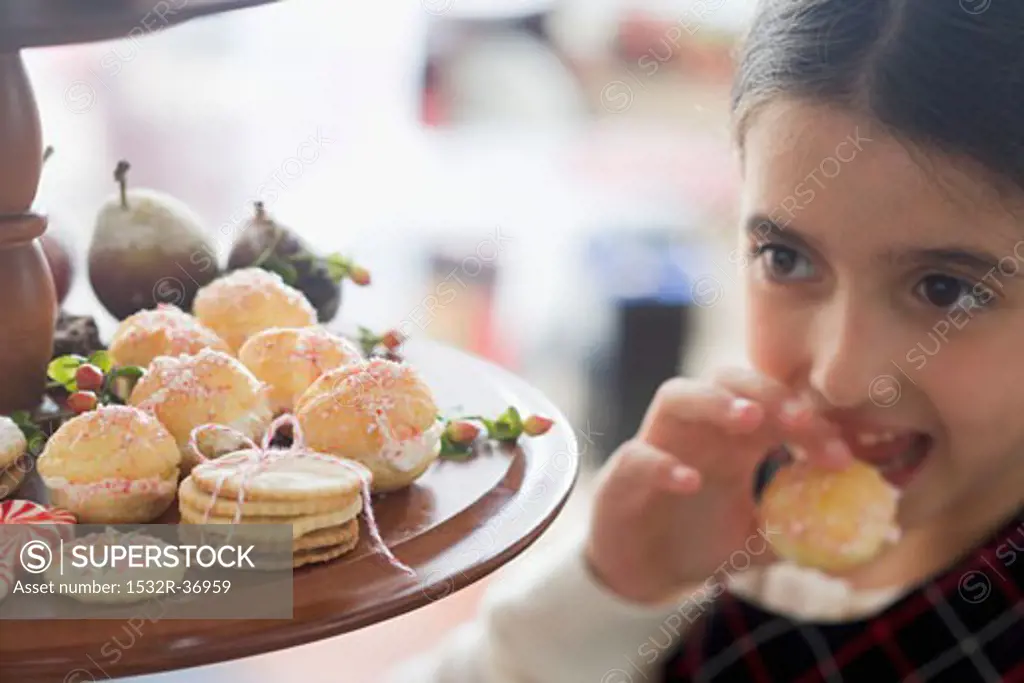 Girl eating profiterole (Christmas)