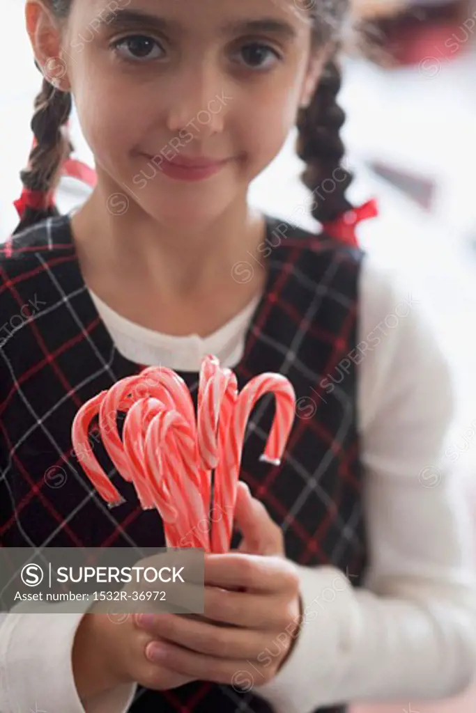 Girl holding candy canes