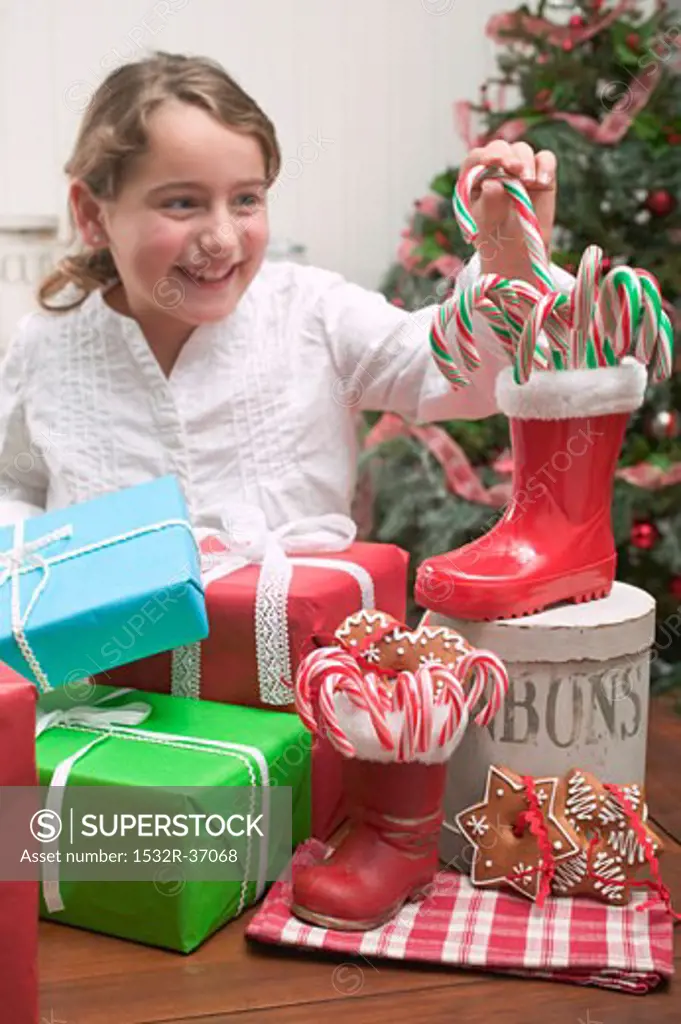 Girl reaching for candy cane