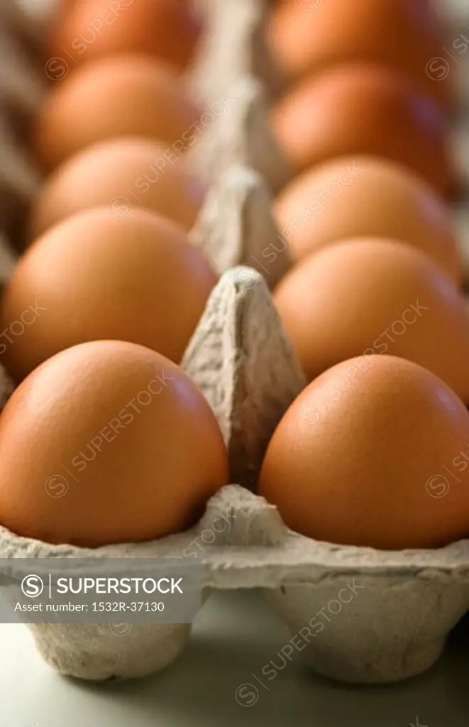 Fresh, brown eggs in an egg box