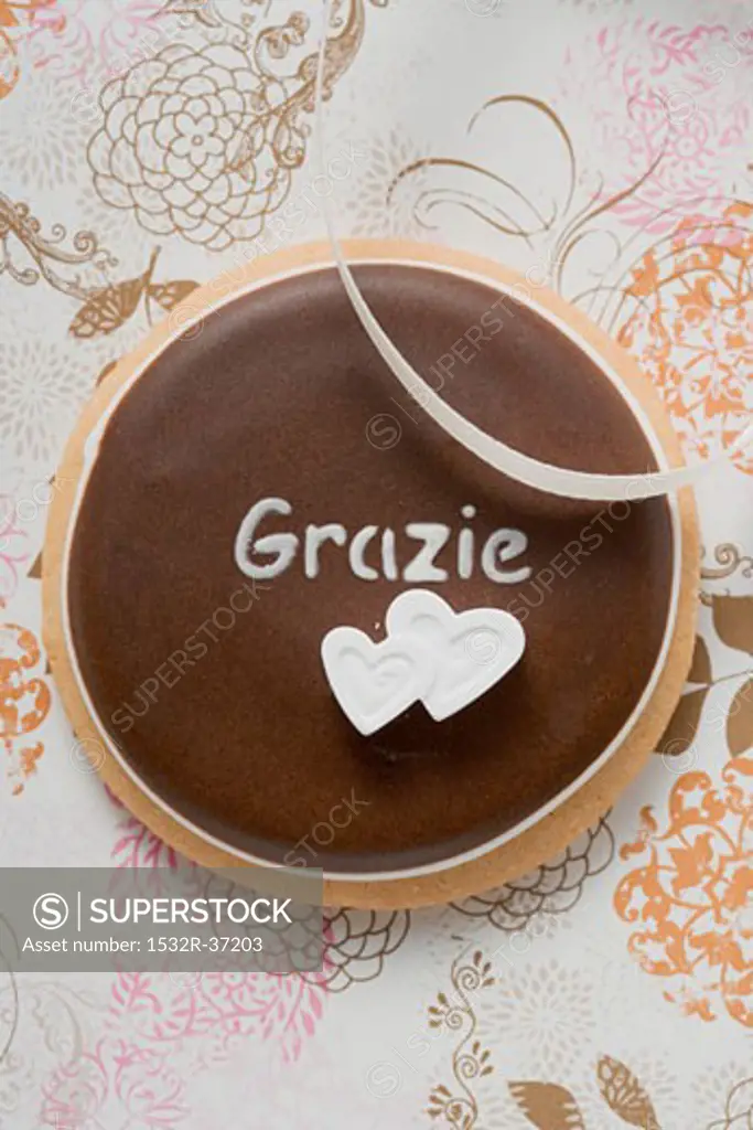A chocolate biscuit with the word 'Grazie' (close-up)