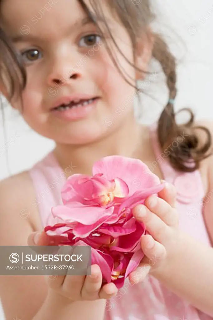 Girl holding rose petals