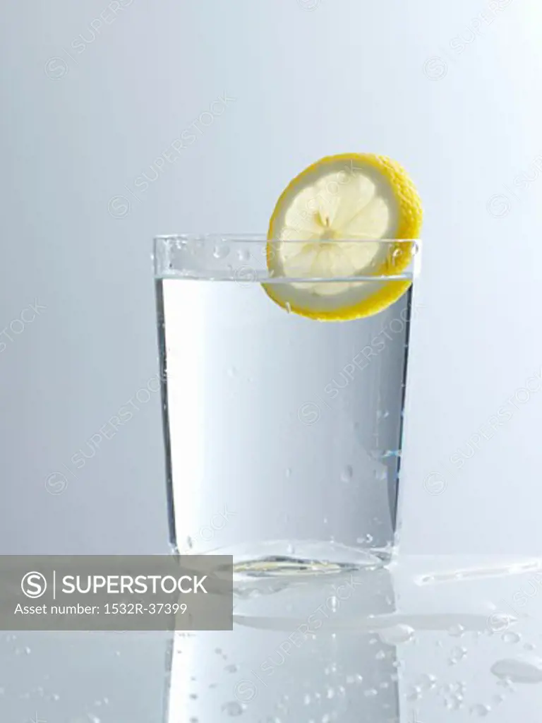 A glass of water with a slice of lemon
