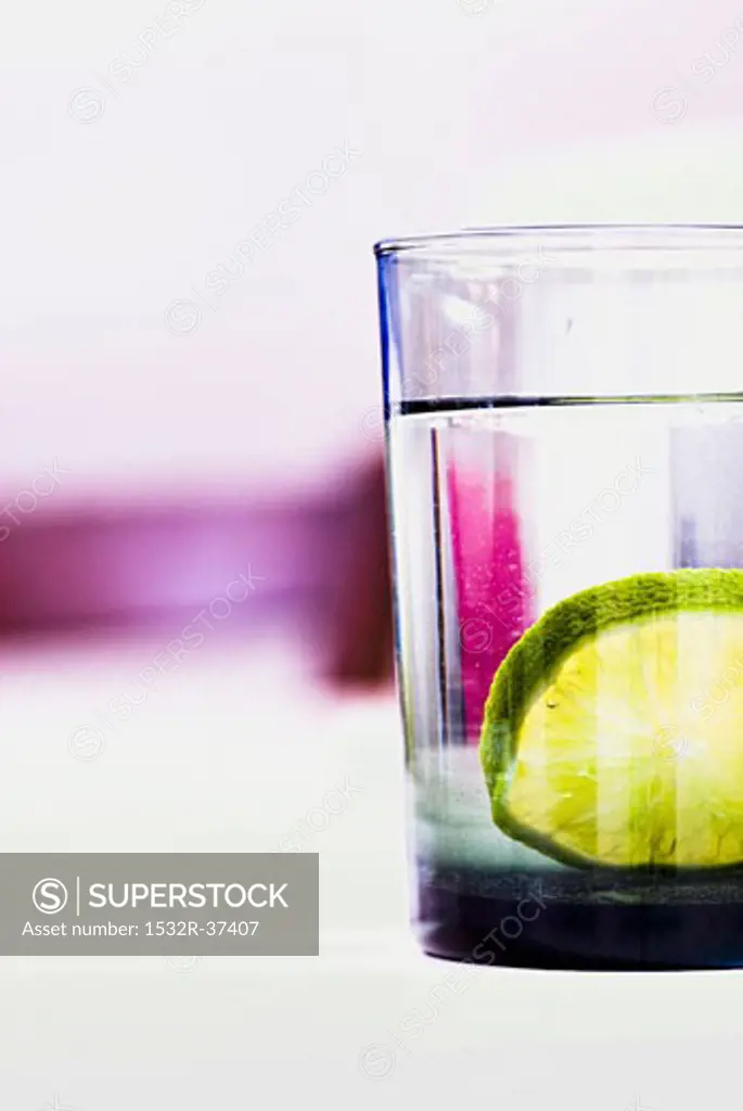 A glass of mineral water with a slice of lime