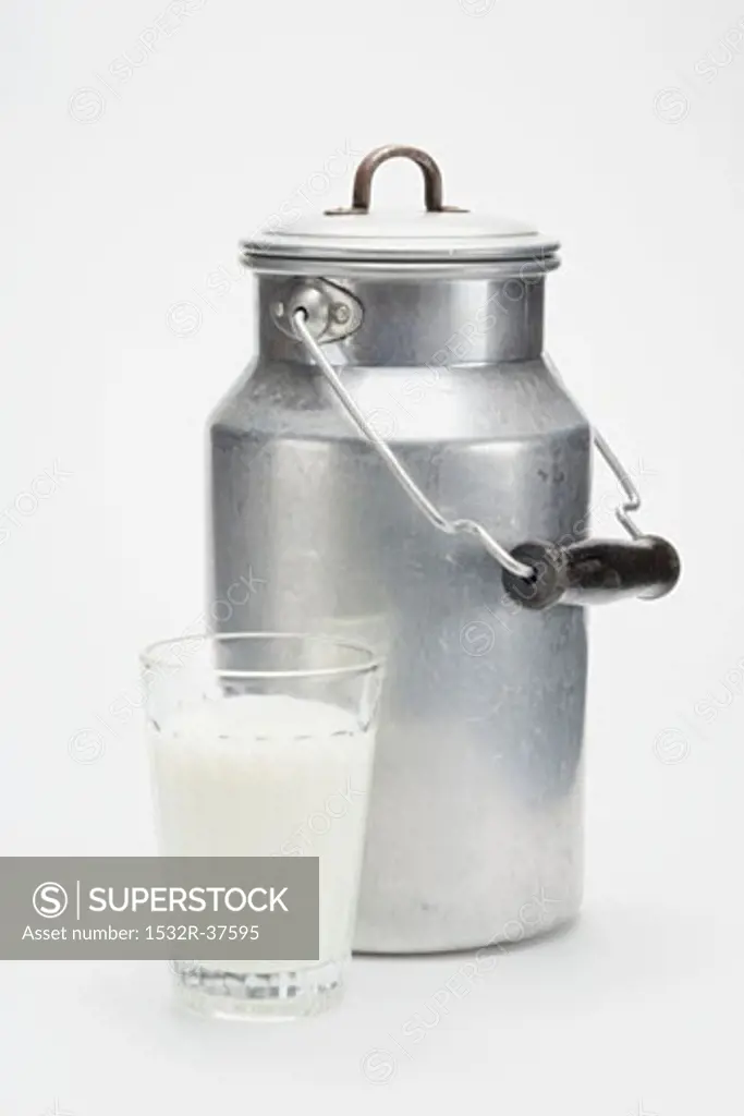 A milk can and a glass of milk
