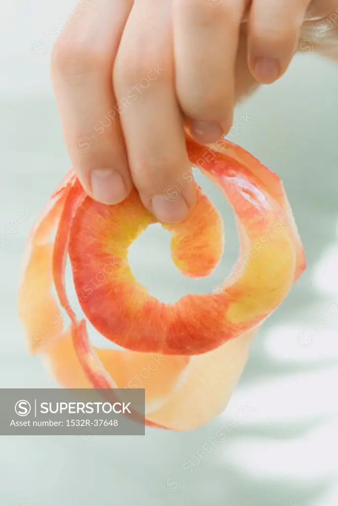 Hand holding apple peel