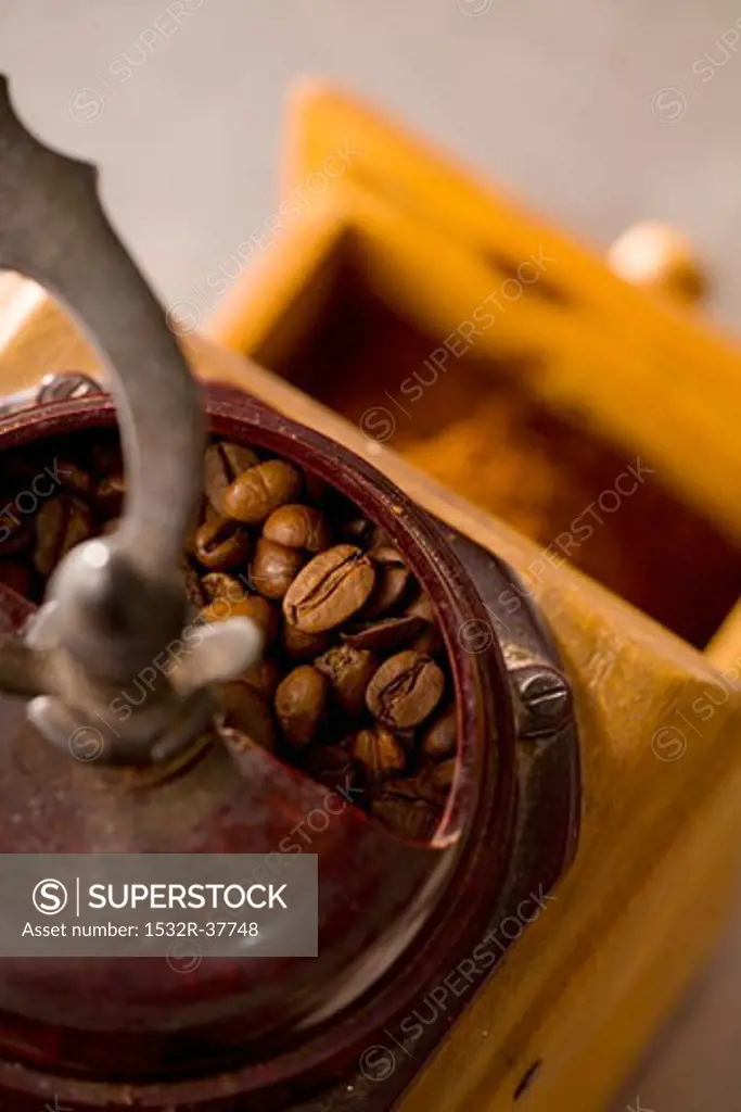 Old coffee mill with coffee beans (from above)