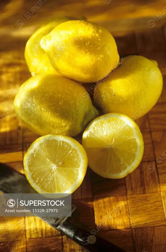 Whole Fresh Lemons with a Halved Lemon, Knife