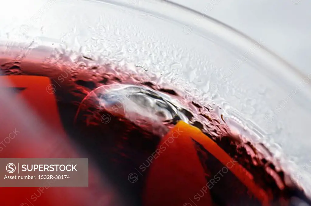 Red fruit juice with ice cubes in a glass