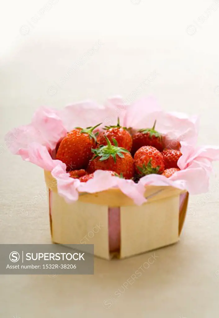 Strawberries in a punnet lined with paper