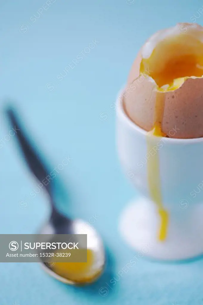 Soft-boiled egg in an eggcup with spoon