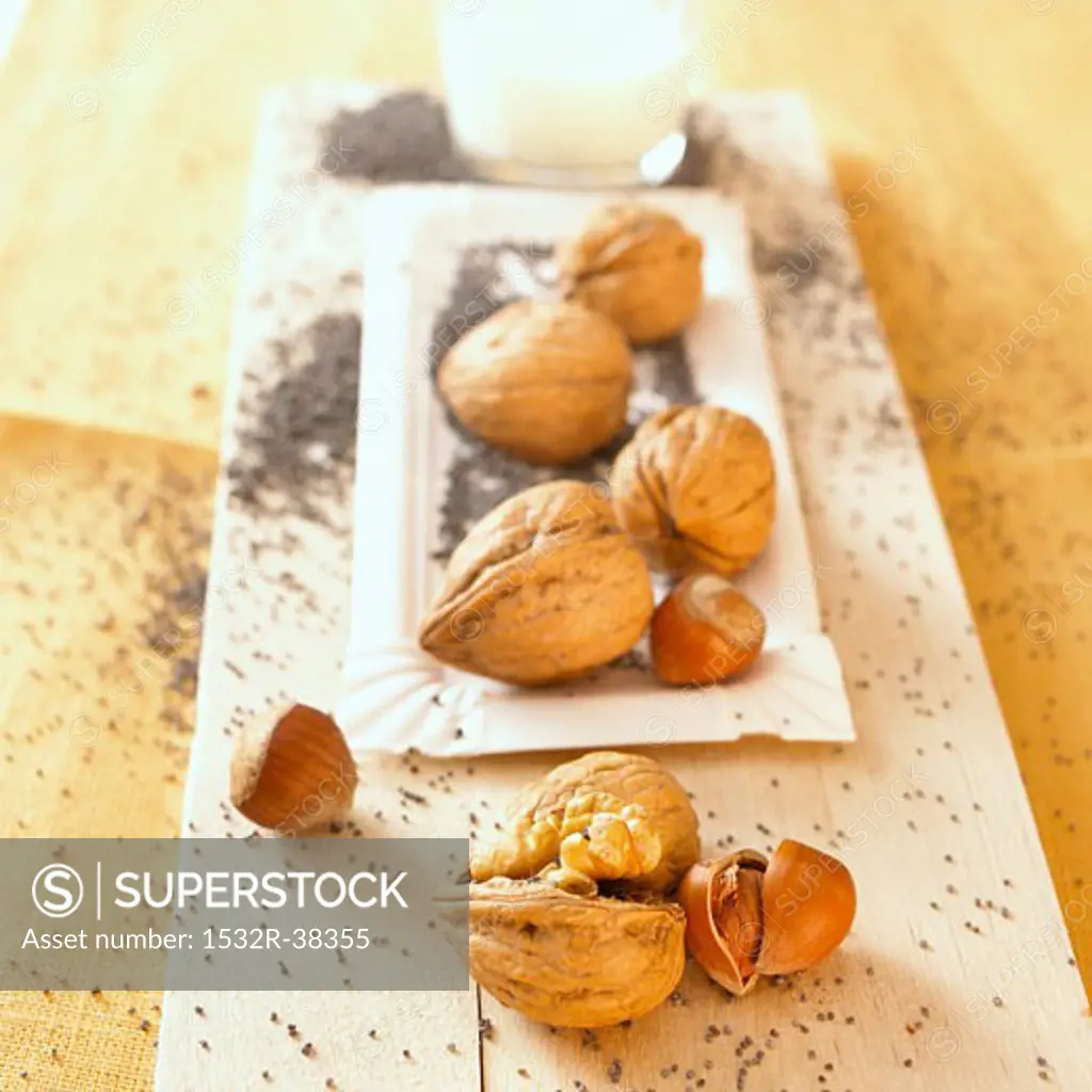 Hazelnuts, walnuts and poppy seeds with a glass of milk