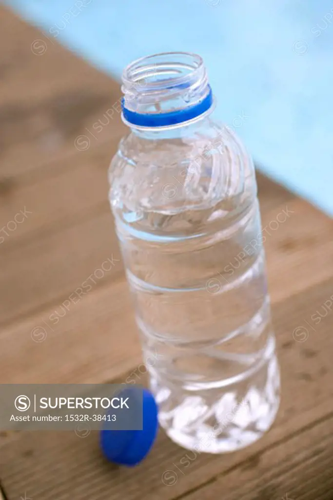Bottle of water by swimming pool