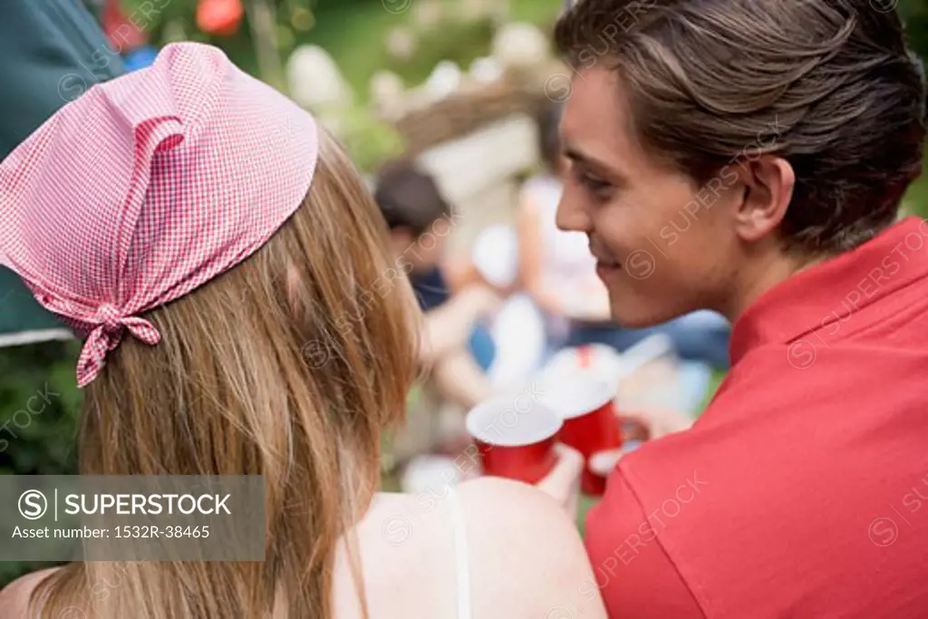 Young couple at a garden party for the 4th of July (USA)