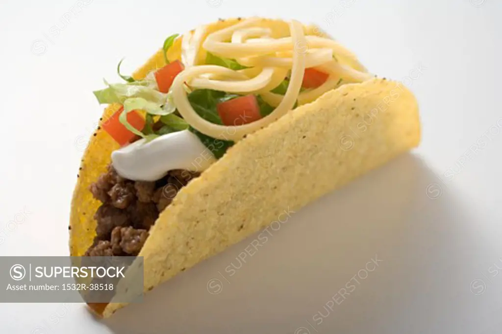 Taco filled with mince, lettuce, cheese and sour cream