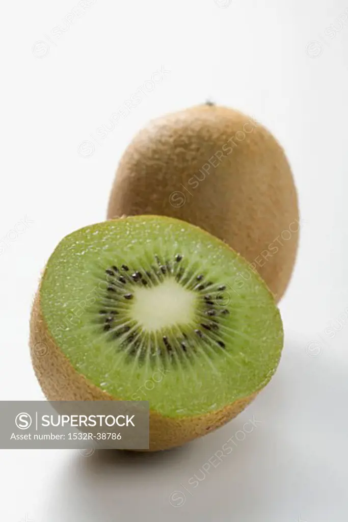 Whole kiwi fruit and half a kiwi fruit