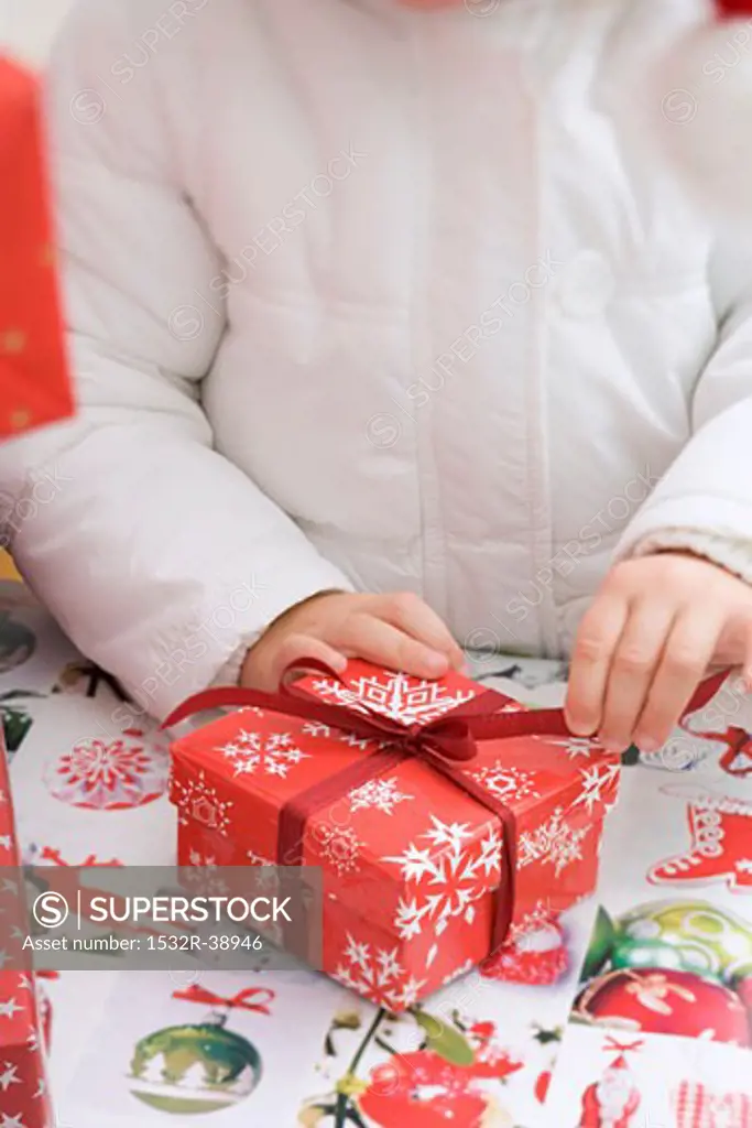 Child opening Christmas parcel