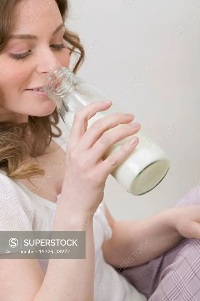 Woman drinking milk out of bottle