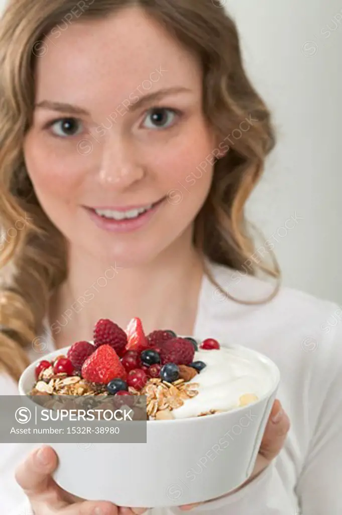 Woman holding berry muesli