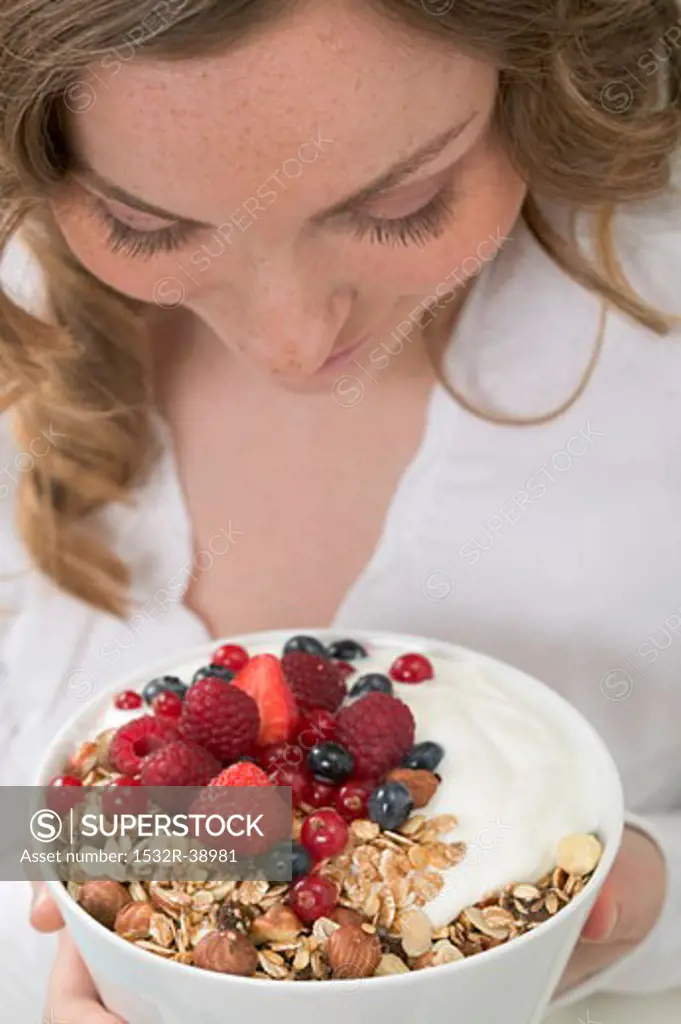 Woman holding berry muesli