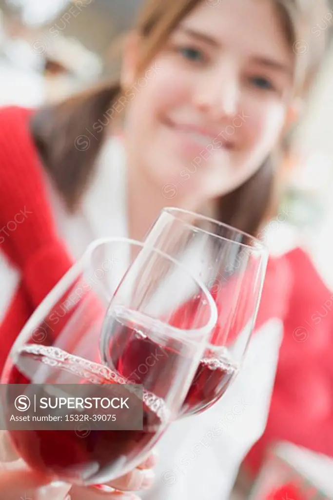 Young woman raising glass of wine (Christmas)